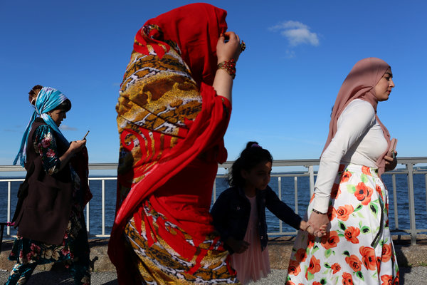 Muslim women walk along the boardwalk at Bensonhurst Park on June 15.