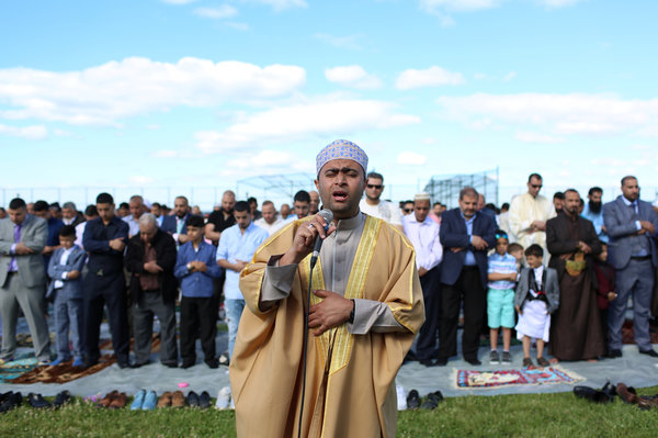 An imam leads Eid al-Fitr prayers at Bensonhurst Park to mark the end of Ramadan on June 15.
