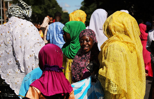Women gather after participating in an outdoor prayer event at Masjid Aqsa-Salam mosque, Manhattan's oldest West African mosq