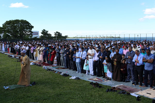 Muslims pray at Bensonhurst Park to celebrate Eid al-Fitr.