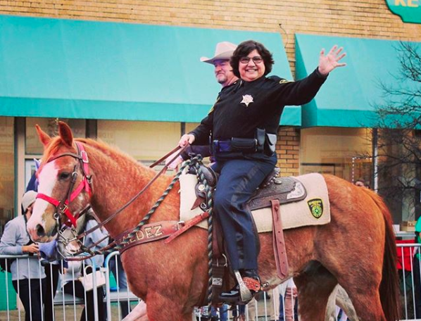 Lupe Valdez&nbsp;rides in a Mardi Gras parade in Dallas in February 2017.