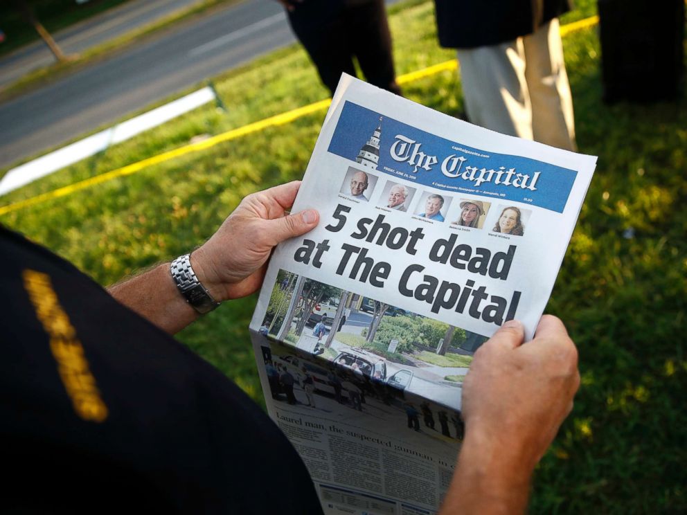 PHOTO: Steve Schuh, county executive of Anne Arundel County, holds a copy of The Capital Gazette near the scene of a shooting at the newspapers office, June 29, 2018, in Annapolis, Md.