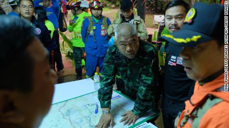 Thai officials plan over a map of the Tham Luang Nang Non caves.