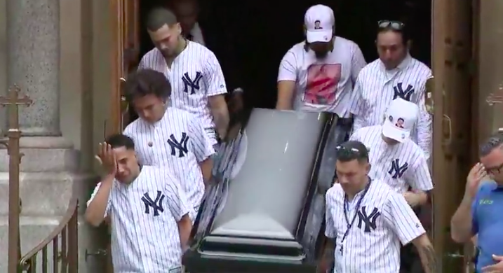 Pallbearers, most wearing matching New York Yankee jerseys, carry the casket at the funeral service on Wednesday for Guzman-F