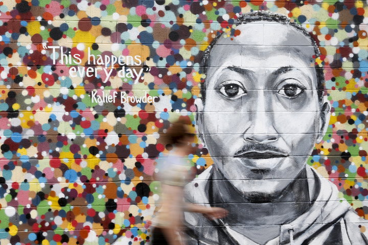 A man walks by a mural honoring Kalief Browder in Queens, New York, June 16, 2015.
