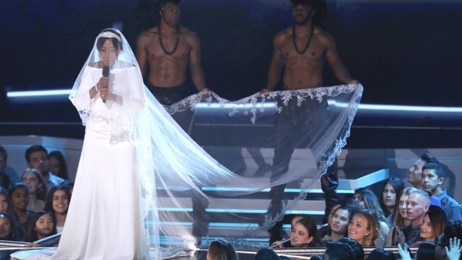 Tiffany Haddish appears on stage at the MTV Movie and TV Awards wearing a full on replica of Meghan Markle's royal wedding gown.