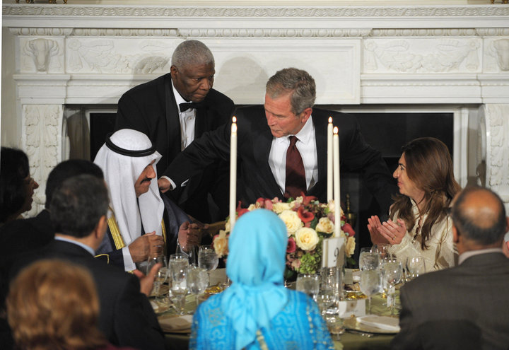 President George W. Bush takes his seat next to Kuwait's former Prime Minister Nasser al-Mohammed al-Ahmed al-Jaber al-Sabah 