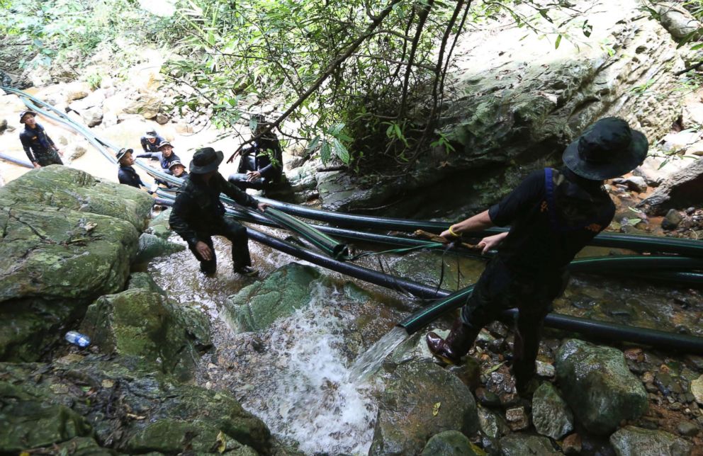 PHOTO: Thai soldiers drag water pipes that will help bypass water from entering a cave where 12 boys and their soccer coach have been trapped since June 23, in Mae Sai, Chiang Rai province, in northern Thailand, July 7, 2018.