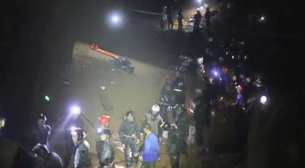 PHOTO: More than 30 rescuers form the two phalanx a bucket brigade to quickly pass the boys along to safety. 