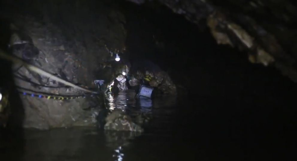 PHOTO: One of the narrow flooded passages of the cave fitted with overhead lights and ropes that the dive team swam through with the rescued boys and coach in tow on a stretcher.