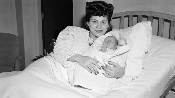 FILE - In this Jan. 10, 1944 file photo, Nancy Sinatra holds her newborn son, Frank, at Margaret Hague Maternity Hospital in Jersey City, N.J. Nancy Sinatra Sr., the childhood sweetheart of Frank Sinatra who became the first of his four wives and the mother of his three children, has died. She was 101. Her daughter, Nancy Sinatra Jr., tweeted that her mother died Friday, July 13, 2018.   (AP Photo/Murray Becker, File)