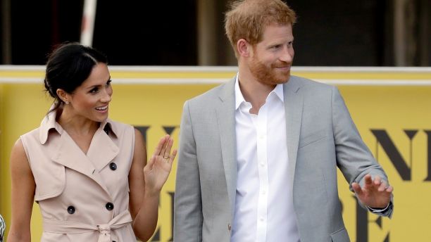 Britain's Prince Harry, right,  and his wife Meghan the Duchess of Sussex wave at onlookers as they arrive for their visit to the launch of the Nelson Mandela Centenary Exhibition, marking the 100th anniversary of anti-apartheid leader's birth, at the Queen Elizabeth Hall in London, Tuesday, July 17, 2018. (AP Photo/Matt Dunham)