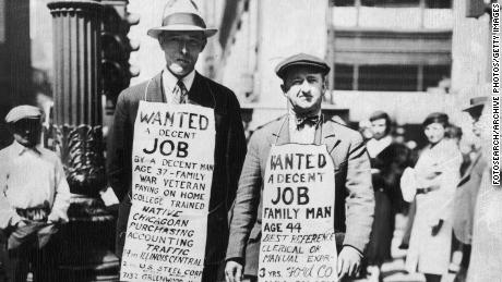 Two men advertising their willingness to find employment - &#39;Wanted, a decent job&#39; - in Chicago during the Great Depression. Chicago, Illinois, in 1934. 