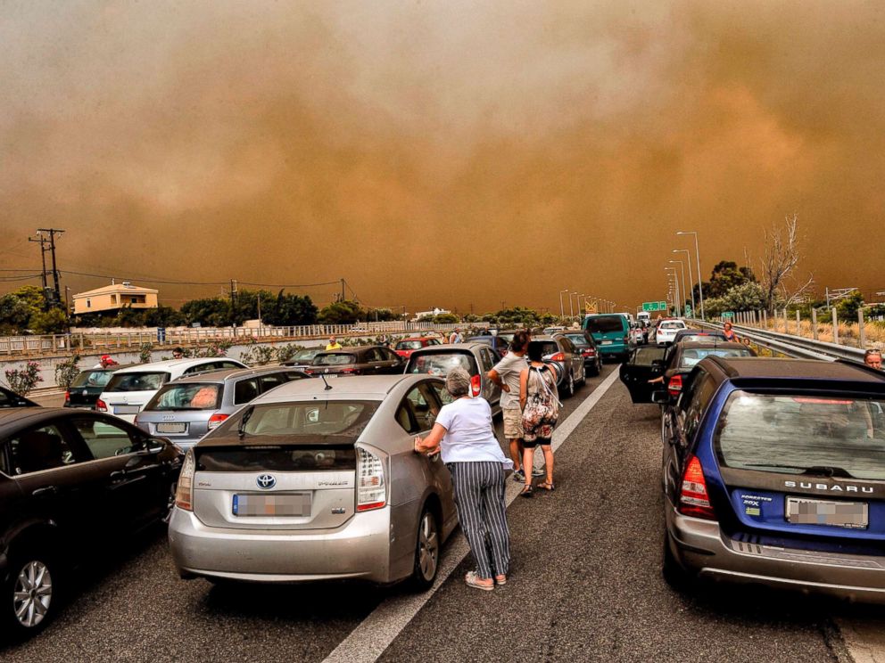 PHOTO: Cars are blocked at the closed National Road during a wildfire in Kineta, near Athens, July 23, 2018.