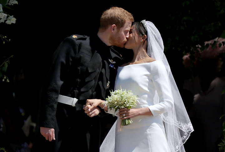 Prine Harry and Meghan, Duchess of Sussex, kiss outside St. George's Chapel in Windsors Castle, just after their wedding.&nbs