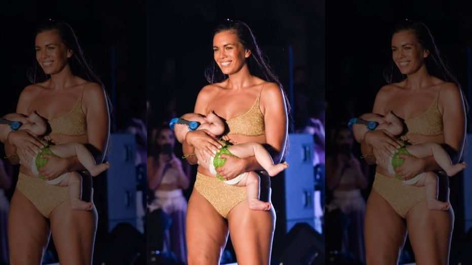 Bikini model Mara Martin breastfeeds a baby on runway at Sports Illustrated's swimsuit show in Miami.