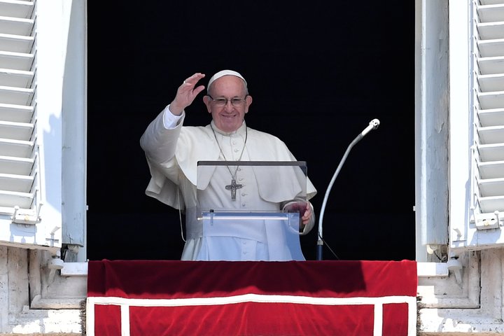 Pope Francis waves to the crowd during the Sunday Angelus prayer at the Vatican on July 15.