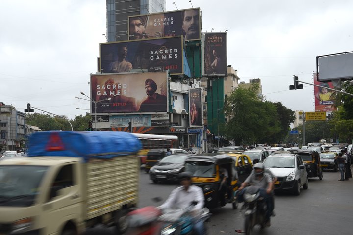 Commuters in Mumbai travel past large billboards for "Sacred Games," India's first Netflix original series,&nbsp;on Wednesday