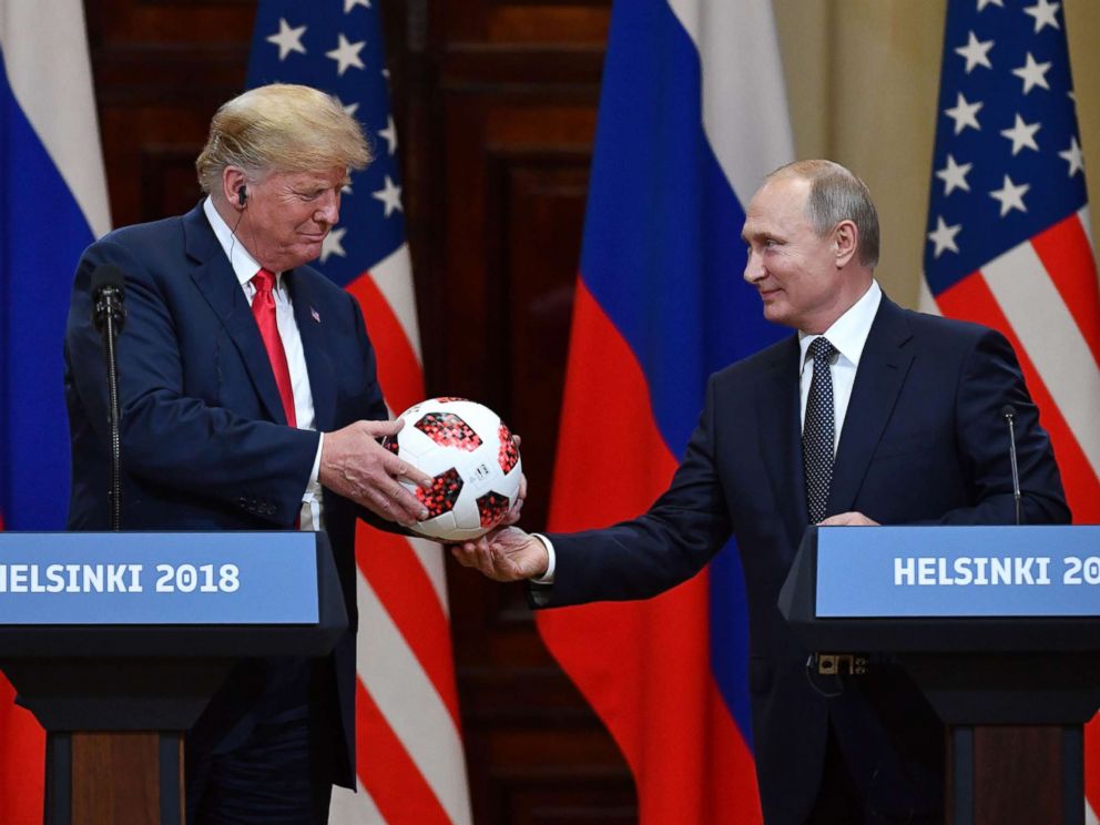 PHOTO: Russias President Vladimir Putin offers a ball of the 2018 football World Cup to President Donald Trump during a joint press conference after a meeting at the Presidential Palace in Helsinki, Finland, July 16, 2018.