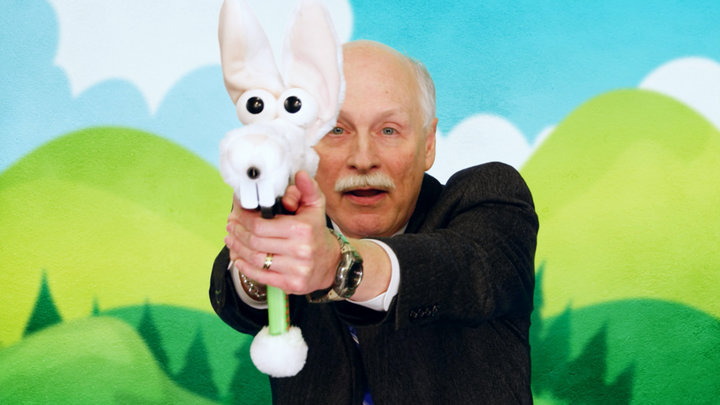 Gun rights advocate Philip Van Cleave participating in an fictional ad campaign for stuffed animal guns for children in the p