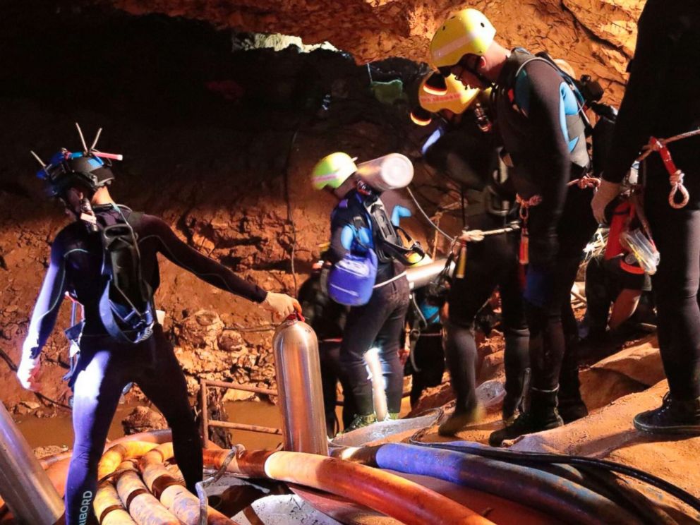 PHOTO: Thai rescue team members walk inside a cave where 12 boys and their soccer coach have been trapped since June 23, in Mae Sai, Chiang Rai province, northern Thailand in this undated photo released by Royal Thai Navy, July 7, 2018.
