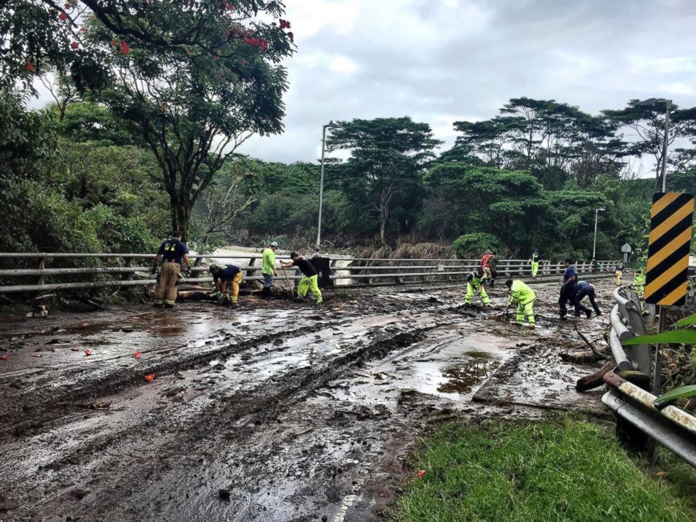 In this photo provided by Jessica Henricks, crews work at clearing damage from Hurricane Lane Friday, Aug. 24, 2018, near Hilo, Hawaii.