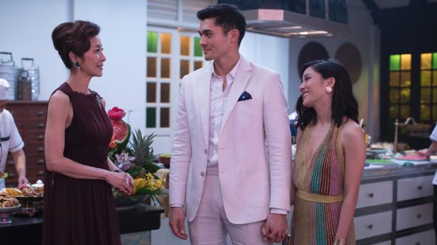 This image released by Warner Bros. Entertainment shows Michelle Yeoh, from left, Henry Golding and Constance Wu in a scene from the film "Crazy Rich Asians."  When Ã¢â¬ÅCrazy Rich AsiansÃ¢â¬Â surpassed expectations and grabbed the top spot in its opening weekend, the film also pulled off another surprising feat. It put Asians of a certain age in theater seats. Younger Asian-Americans have been flocking with their parents to see the first movie in 25 years with an all-Asian cast. (Sanja Bucko/Warner Bros. Entertainment via AP)