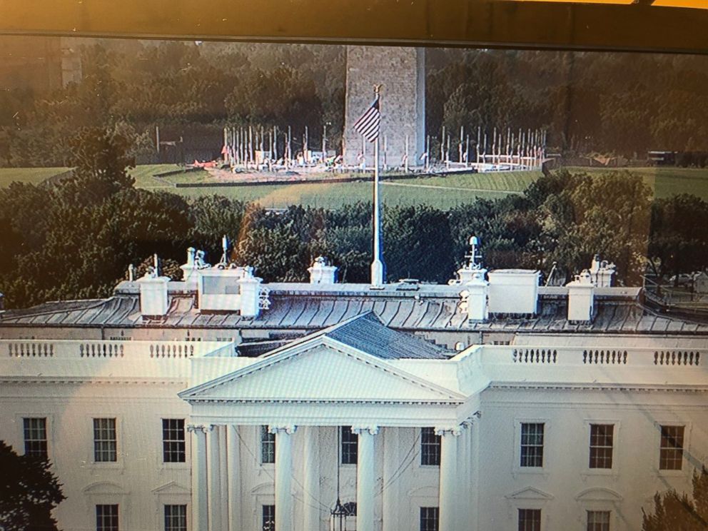 PHOTO: Camera shot facing south over the White House - you can see the flag at the WH at full staff while the flags surrounding the Washington Monument are lowered as of 5:13 am on Aug, 27, 2018.
