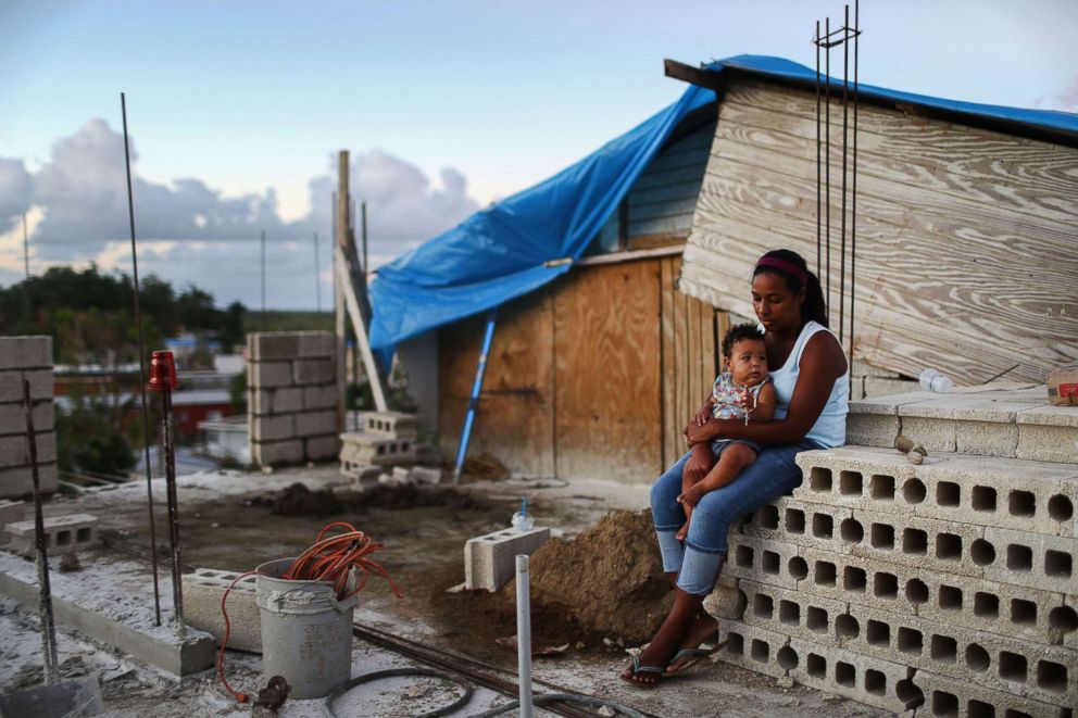 PHOTO: Mother Isamar holds her baby Saniel at their home under reconstruction following Hurricane Maria, Dec. 23, 2017 in San Isidro, Puerto Rico. Their neighborhood remained without electricity nearly three months after Hurricane Maria made landfall.