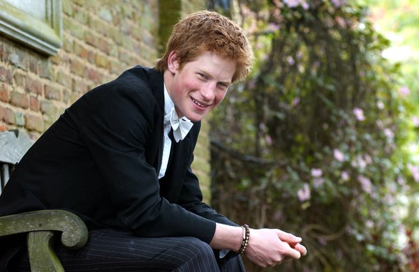 Prince Harry poses on a bench at Eton on May 12, 2003.
