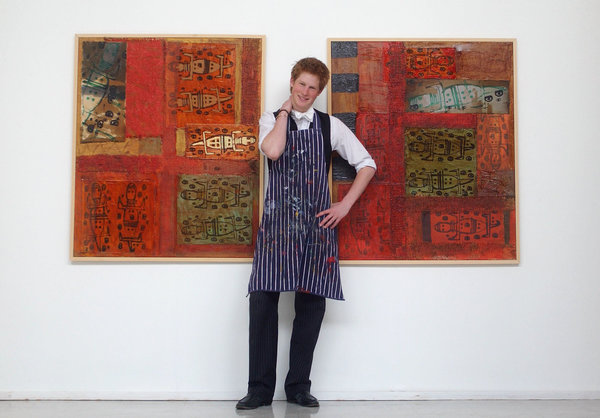 Prince Harry stands between two of his artworks on May 12, 2003, in the Drawing School at Eton College.