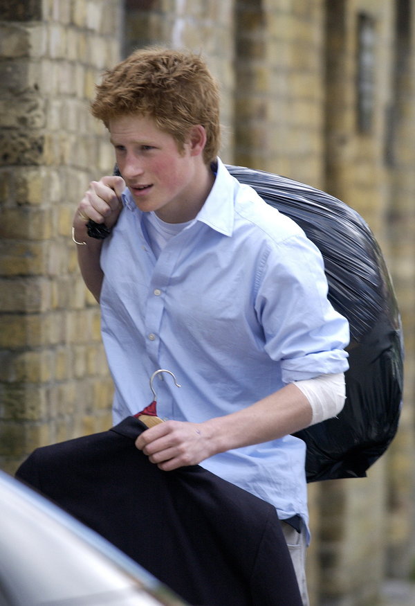 Prince Harry carrying his belongings in a black trash bag on his last day of school at Eton.&nbsp;