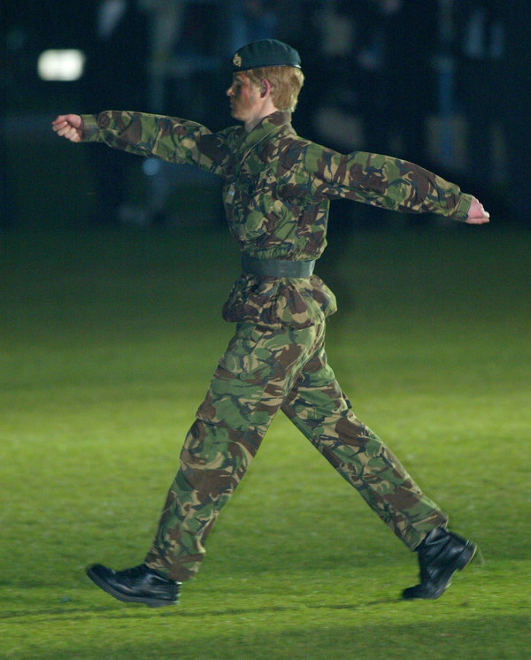 Prince Harry wears camouflage as he commands the cadets of Eton's Combined Cadet Forces during their annual tattoo.