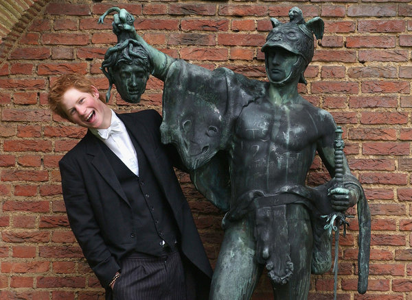 Prince Harry poses next to a bronze statue of Perseus holding the Gorgon's head on May 12, 2003, in the King of Siam's Garden