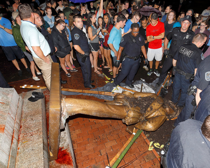 Police and protesters surround the toppled statue of a Confederate soldier nicknamed Silent Sam on the University of North Ca