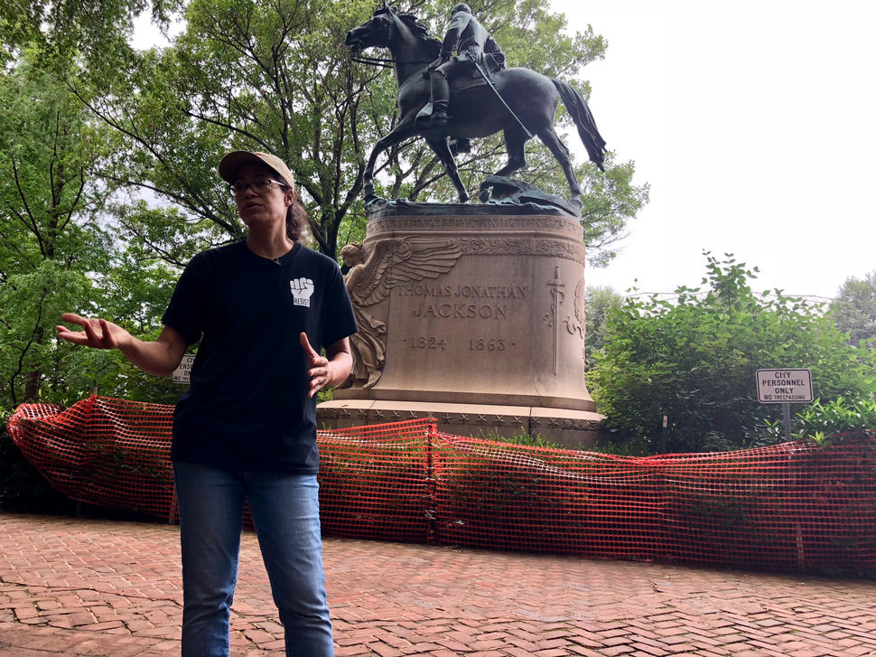 Jalane Schmidt talks in front of a Charlottesville monument to Stonewall Jackson, right in front of a courthouse in town.