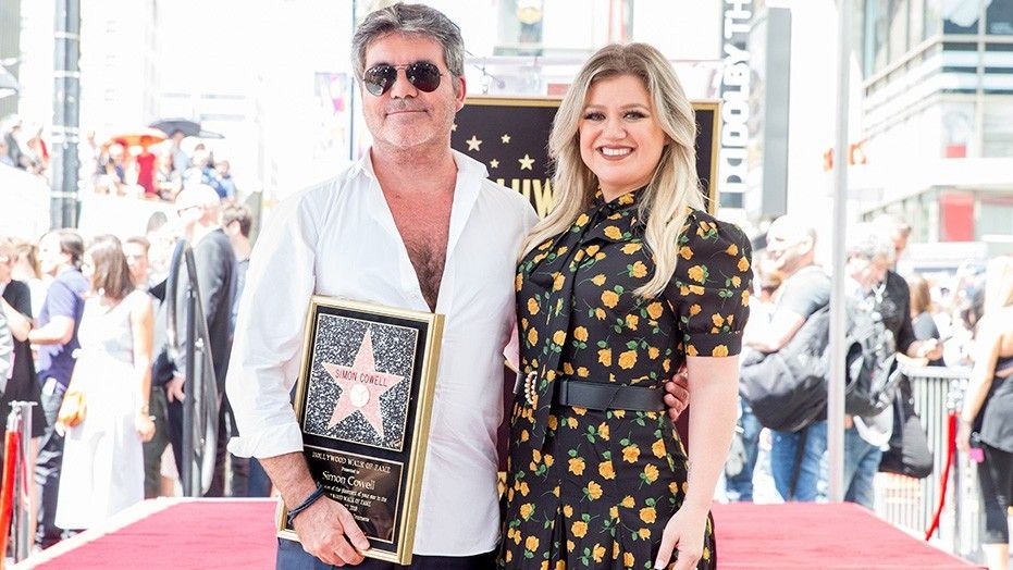 Simon Cowell and Kelly Clarkson attend a ceremony honoring Cowell with a star on the Hollywood Walk of Fame on August 22, 2018.