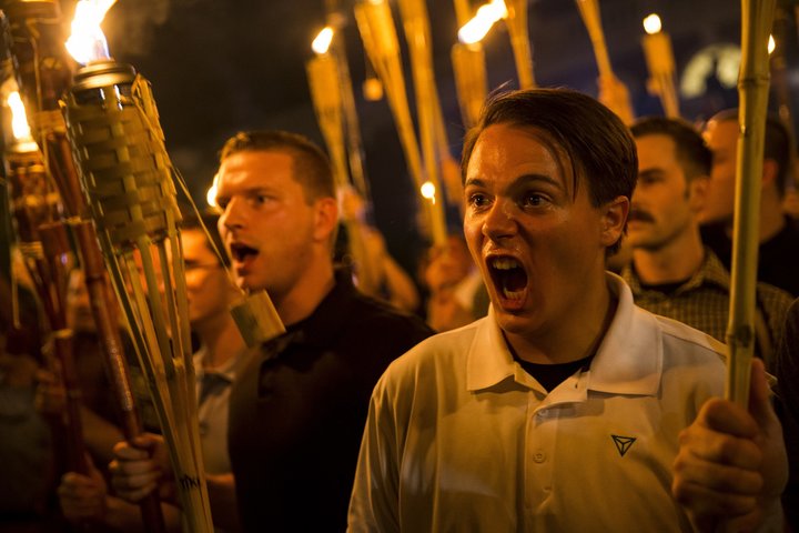 Peter Cvjetanovic, right, appears with neo-Nazis, alt-right supporters and white nationalists holding tiki torches and chanti
