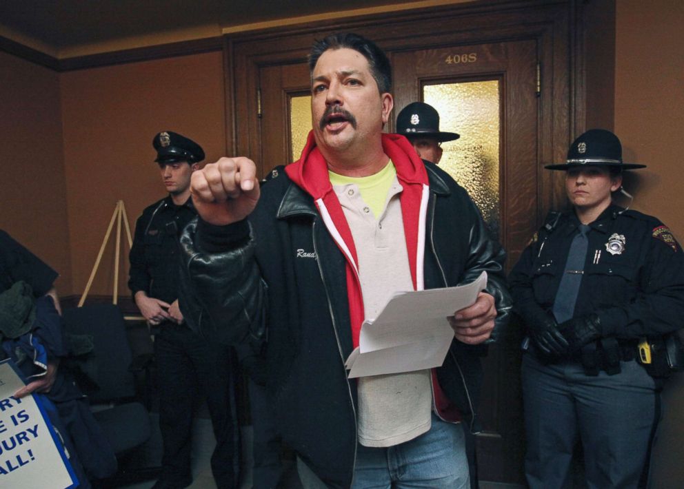PHOTO: Randy Bryce, of Caledonia, Wis. reads his testimony outside a hearing room that is barricaded by police after he was not able to speak during a meeting for a right-to-work bill at the Wisconsin State Capitol in Madison, Wis., Feb. 24, 2015.