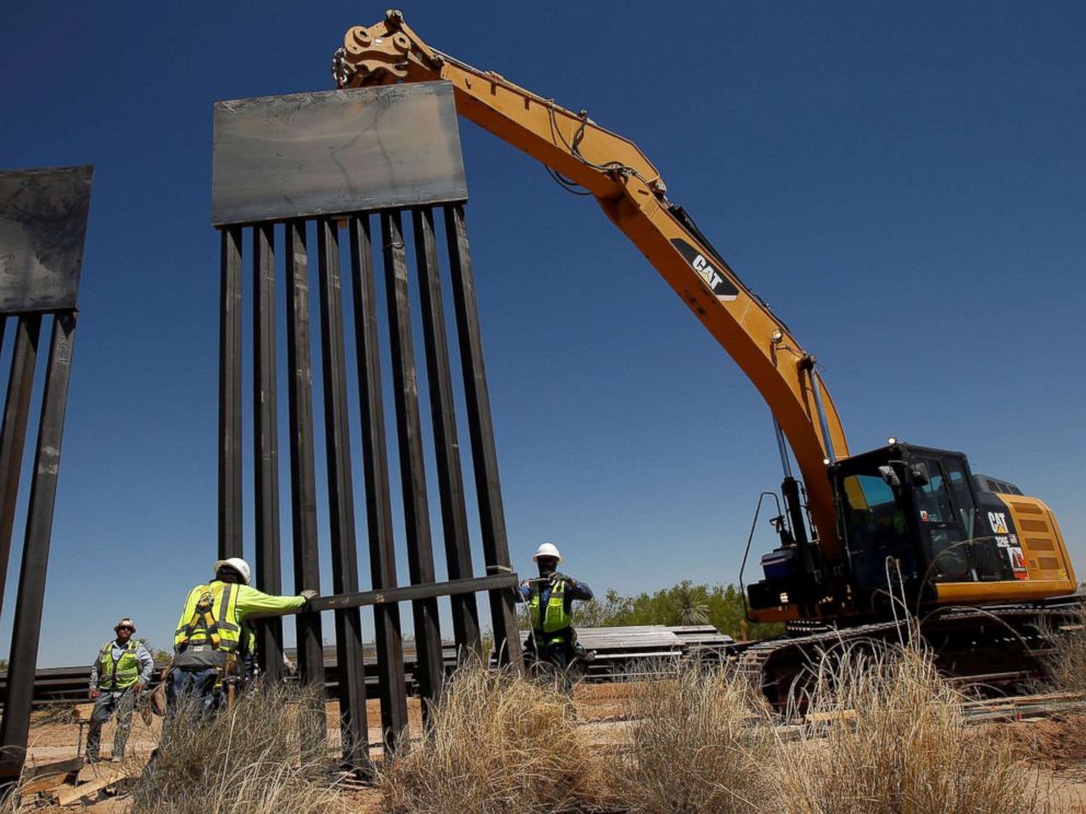 PHOTO: Construction workers place a panel of new bollard wall with the help of heavy machinery in Santa Teresa, New Mexico, as seen from the Mexican side of the border in San Jeronimo, on the outskirts of Ciudad Juarez, Mexico, April 23, 2018.