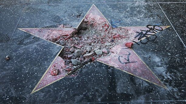FILE - This Wednesday, July 25, 2018 file photo shows Donald Trump's vandalized star on the Hollywood Walk of Fame in Los Angeles. On Friday, Aug. 3, 2018, The Associated Press has found that stories circulating on the internet that the man arrested for destroying the star will lose his right to vote for the rest of his life, are untrue. (AP Photo/Reed Saxon)