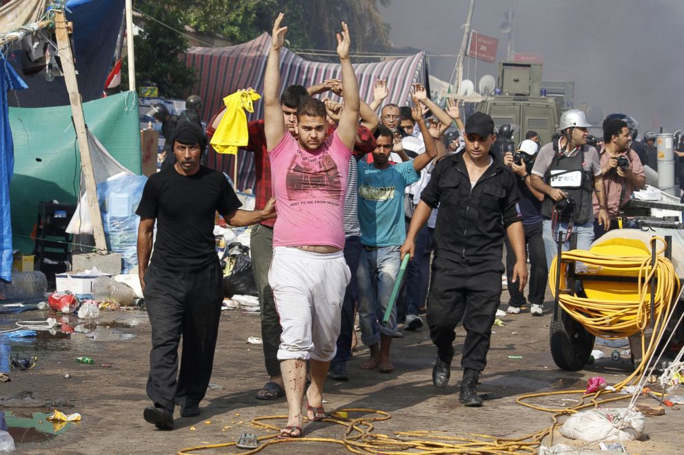 PHOTO: Egyptian security forces escort detained supporters of Egypts ousted president Mohamed Morsi during an operation to dismantle a huge pro-Islamists protest camp near Rabaa al-Adawiya mosque in Cairo, Aug. 14, 2013.
