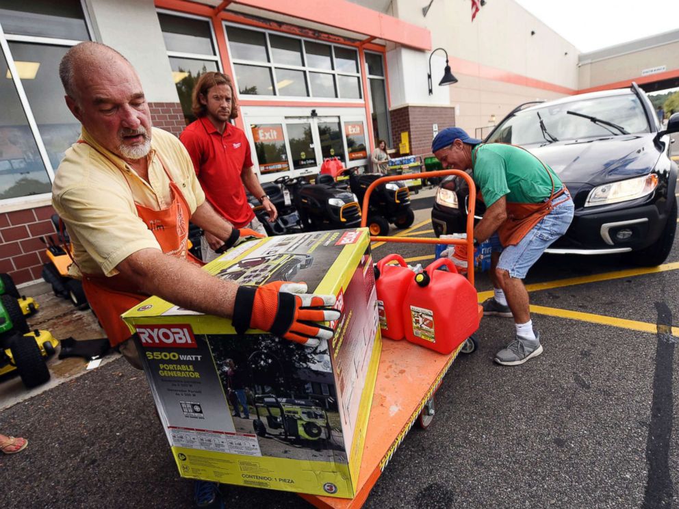 PHOTO: Jim Craig, David Burke and Chris Rayner load generators as people buy supplies at The Home Depot on Monday, Sept. 10, 2018, in Wilmington, N.C.