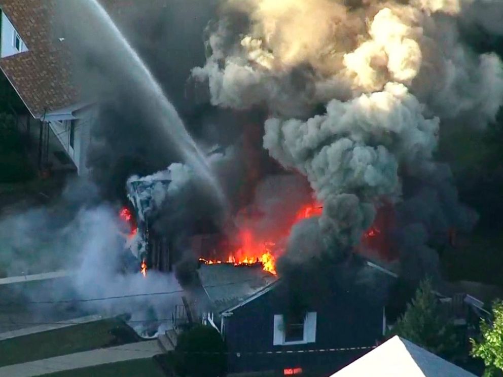 In this image take from video provided by WCVB in Boston, flames consume the roof of a home in Lawrence, Mass, a suburb of Boston, Thursday, Sept. 13, 2018. Emergency crews are responding to what they believe is a series of gas explosions that have d