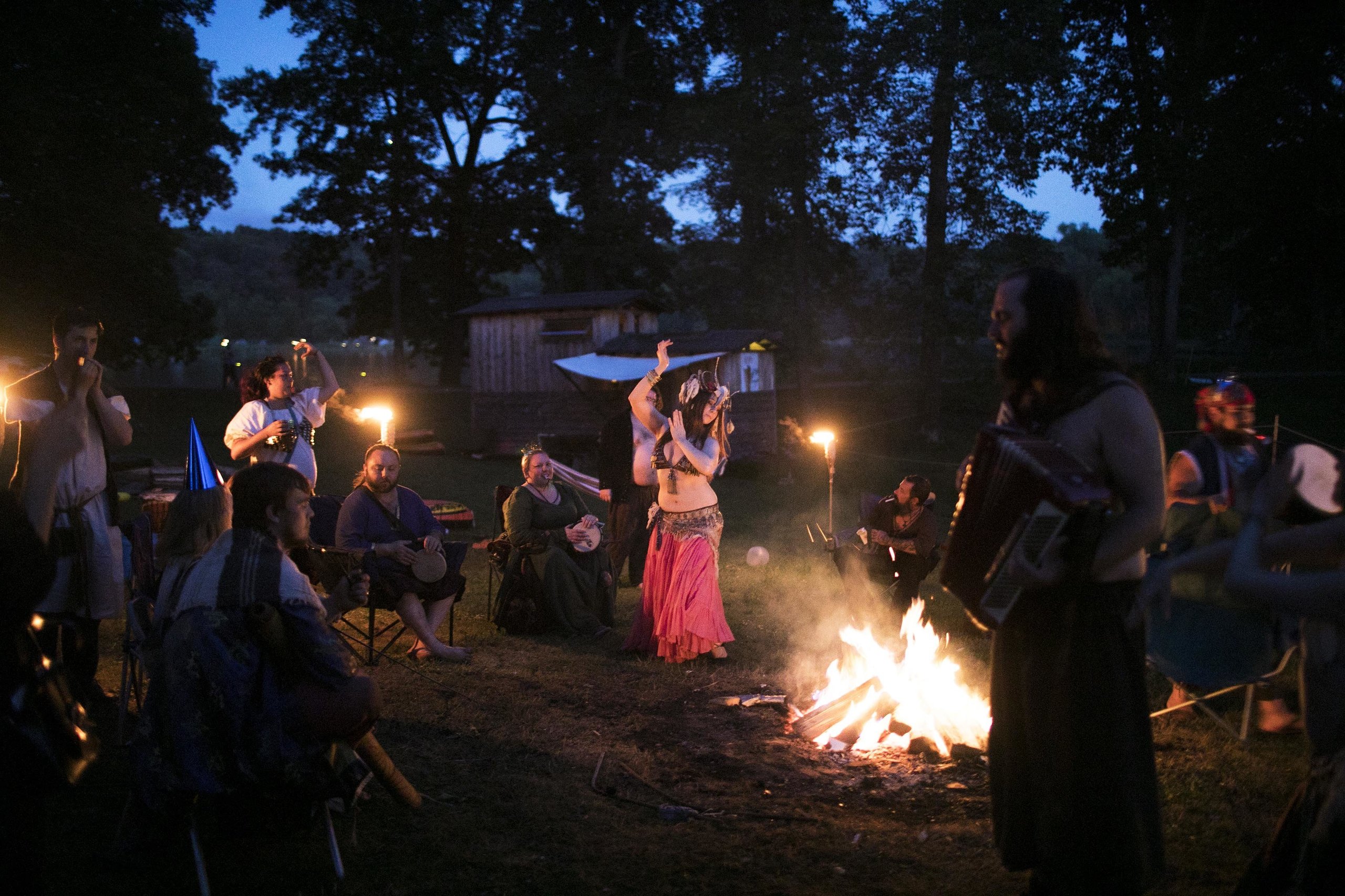 Rag attendees drink, dance and make merriment around the fire at an after-hours campout.