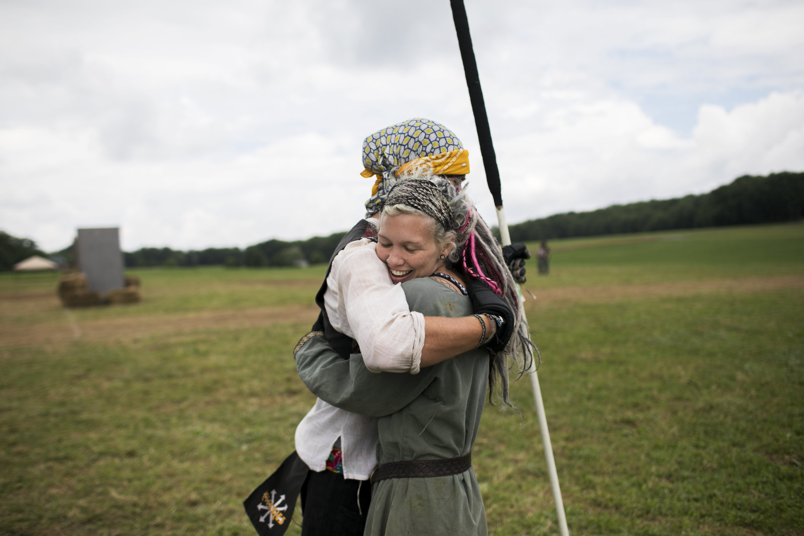 Attendees hug on the field while training for battle.&nbsp;