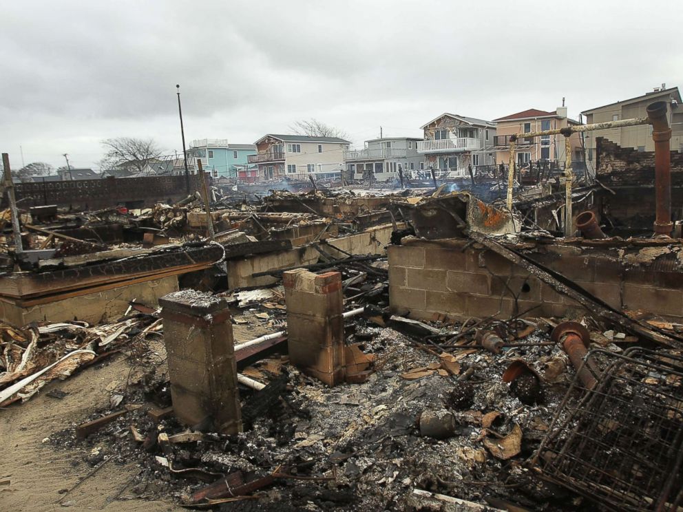 PHOTO: Homes sit smoldering after Hurricane Sandy on Oct. 30, 2012 in the Breezy Point Neighborhood of the Queens borough of New York City.