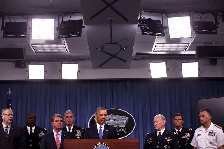 President Barack Obama briefs reporters on U.S. efforts against the self-described Islamic State. Obama expanded the 2001 aut