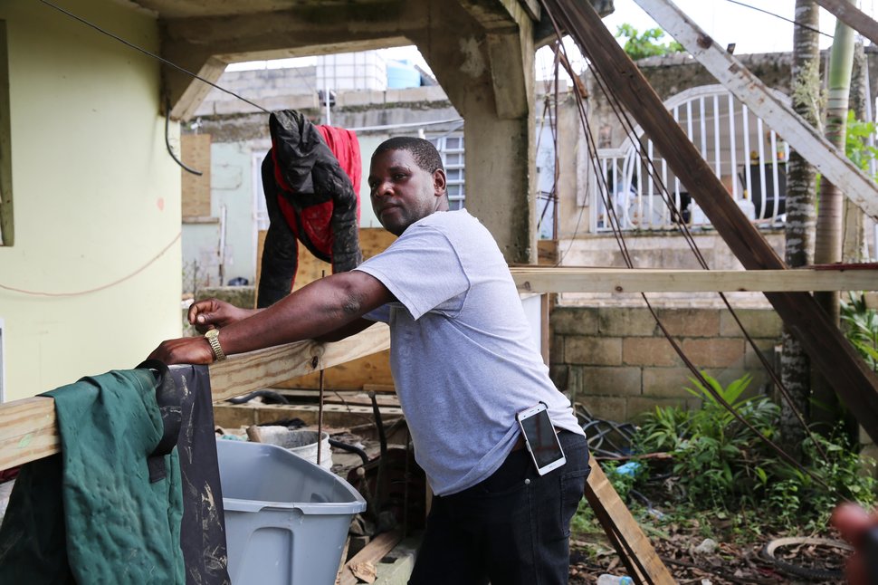 After sorting through his damaged belongings, Juan Medina-Dishmey rests on his front porch three weeks after the storm.&nbsp;