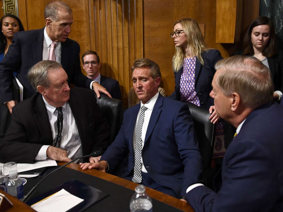 Senate Judiciary Committee member Sen. Jeff Flake speaks with committee colleagues during a hearing in Washington on Sept. 28, 2018, after requested a delay for a floor vote to allow for an FBI investigation.